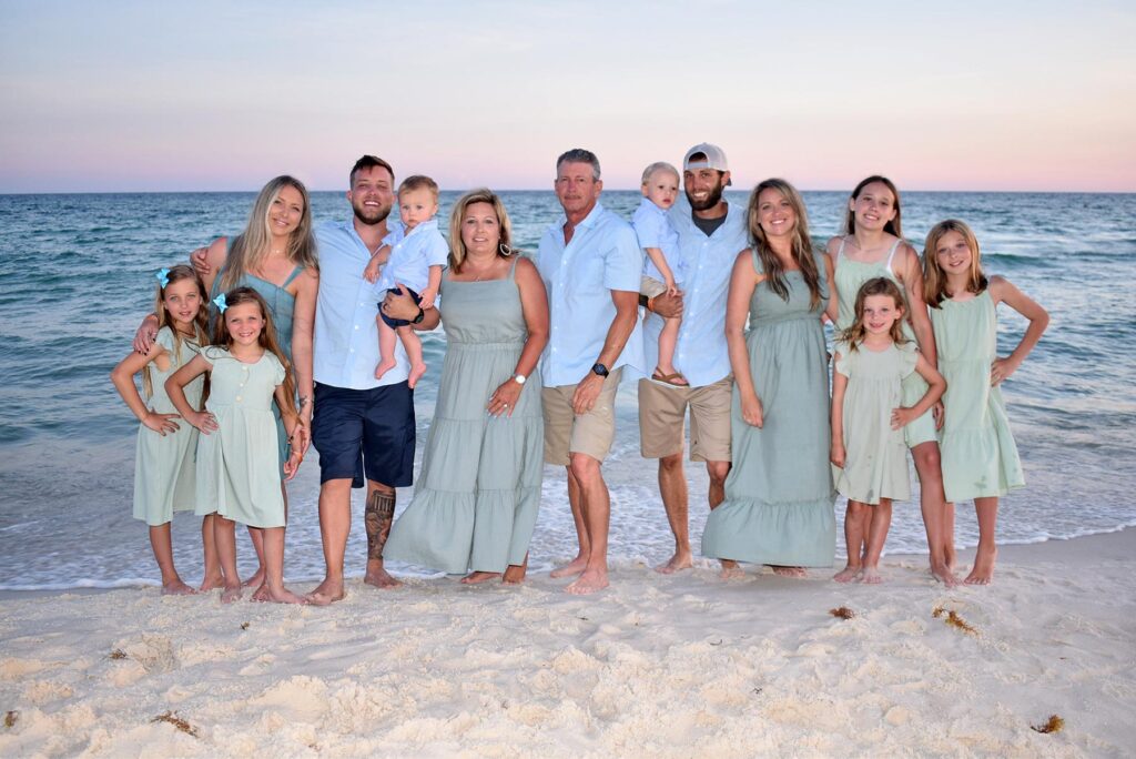 large group photo at the beach with blue color scheme