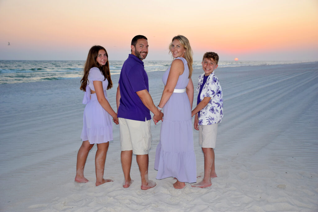 Standing family photo on beach.