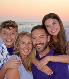 Family photographer in Panama City Beach capturing fall sunset.