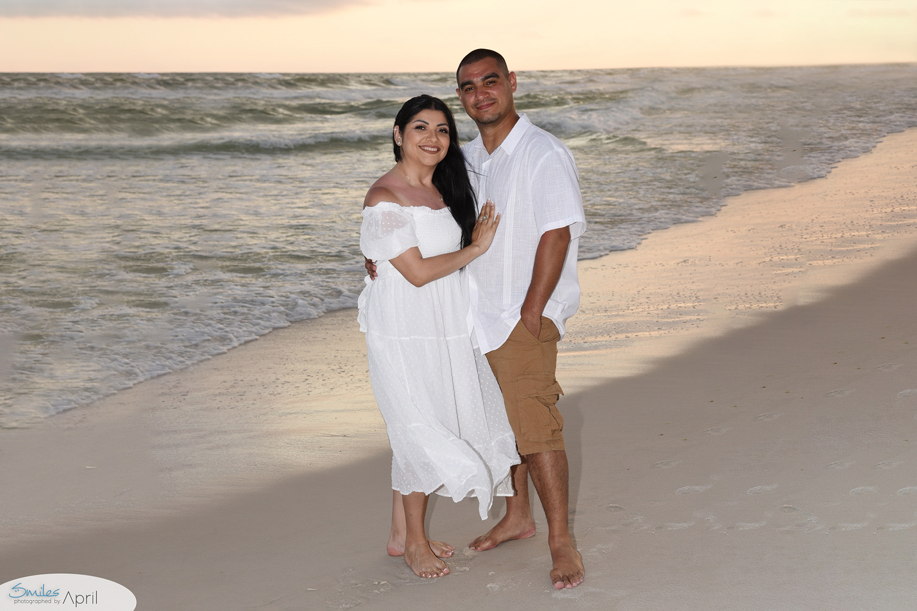 Couple Photographer takes image near waterline for a romantic pose.